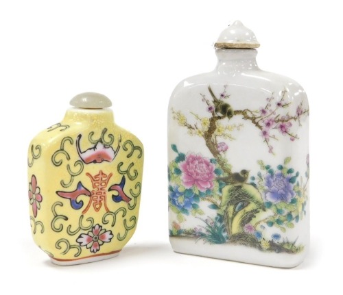 A Chinese porcelain snuff bottle, decorated with birds and flowers, verso script, 8.5cm high, and a famille jaune porcelain snuff bottle, decorated with bats and flowers, 6cm high. (2)