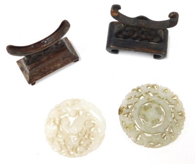 Three Chinese carved jade bi discs, one circular carved with a parrot and flowers, 5cm wide, another with flowers and leaves, 6cm wide, and an oblong disc decorated with a vase, framed by birds, 4.5cm wide, all on wooden stands. - 2