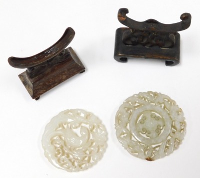 Three Chinese carved jade bi discs, one circular carved with a parrot and flowers, 5cm wide, another with flowers and leaves, 6cm wide, and an oblong disc decorated with a vase, framed by birds, 4.5cm wide, all on wooden stands. - 3