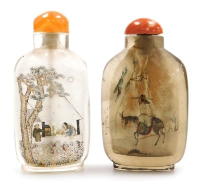 A Chinese inside painted snuff bottle, decorated to the obverse with figures in a house with trees, reverse with script, 7cm high, and a further inside painted snuff bottle, decorated to the obverse with a figure riding an ass, reverse with a fisherman in