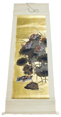 A 19thC Chinese scroll painting, of mandarin ducks and lotus flowers, on a gold ground, 133cm x 43cm. - 2