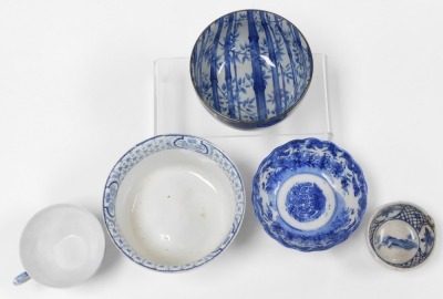 A group of Oriental blue and white pottery and porcelain, including tea wares, vases, seated figure of an emperor, bowls, and a candle holder. (a quantity) - 5