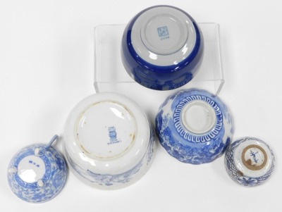 A group of Oriental blue and white pottery and porcelain, including tea wares, vases, seated figure of an emperor, bowls, and a candle holder. (a quantity) - 6