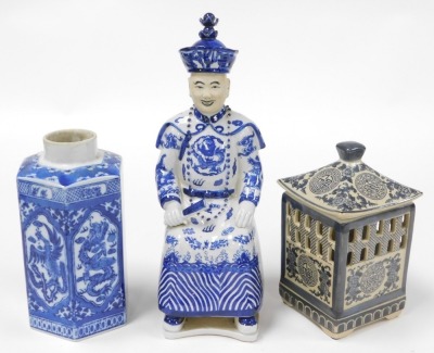 A group of Oriental blue and white pottery and porcelain, including tea wares, vases, seated figure of an emperor, bowls, and a candle holder. (a quantity) - 7