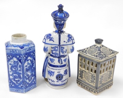 A group of Oriental blue and white pottery and porcelain, including tea wares, vases, seated figure of an emperor, bowls, and a candle holder. (a quantity) - 8