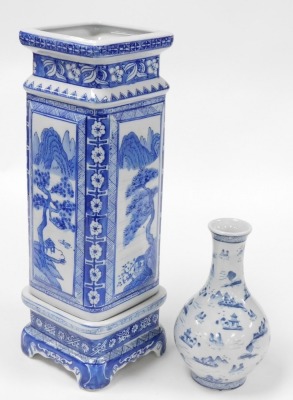 A group of Oriental blue and white pottery and porcelain, including tea wares, vases, seated figure of an emperor, bowls, and a candle holder. (a quantity) - 10