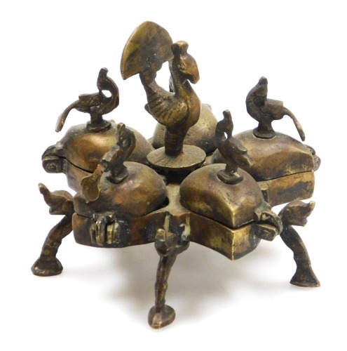 An early 20thC Indian brass Kumkum spice box, of five lidded star form, with bird and peacock finials, raised on elephant's head and scroll feet, 9cm wide.