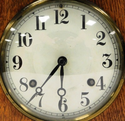 An Edwardian oak cased mantel clock, circular enamel dial bearing Arabic numerals, eight day American movement, New Haven USA, with coil strike, the case of architectural form, raised on brass bun feet, with pendulum and key, 32cm high, 23cm wide. - 2