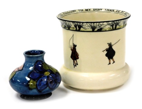 A Moorcroft Clematis pattern pottery vase, of squat baluster form, bears paper label, potters to the late Queen Mary, 7cm high, together with a Royal Doulton Issaac Walton wear pottery vase, designed by Noke, decorated with a band of fisherman and to the 