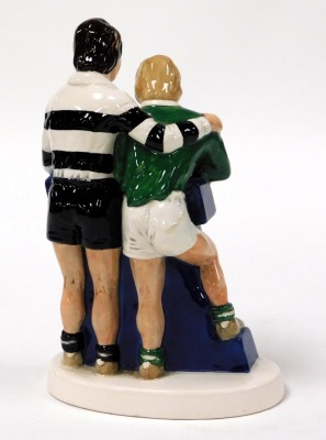 A Beswick Worthington E pottery advertising figure group, featuring two rugby players resting against the letter E, printed mark, 22cm high. - 2