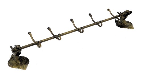 A brass wall hanging coat rack, the wall mounts formed as horse's head, on a circular and leaf cast backing, flanking five hooks, 102cm wide.