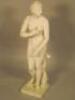 A marble bust of a female nude figure standing beside a dolphin