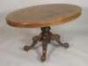 A Victorian burr walnut oval breakfast table on a leaf carved column with four downswept legs with b