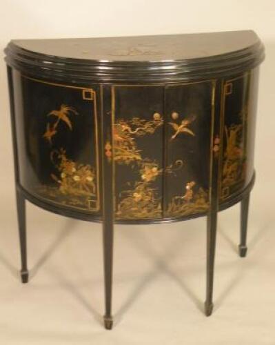 An early 20thC black japanned demi-lune side cabinet decorated in Chinese style with figures