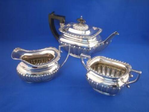 A silver associated three piece part fluted tea service