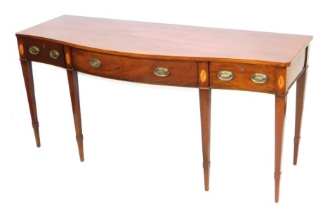 A George III serpentine mahogany serving table, with patera inlay, the top above one long flanked by two short drawers, raised on tapering square legs, 88cm high, 187cm wide, 69cm deep.