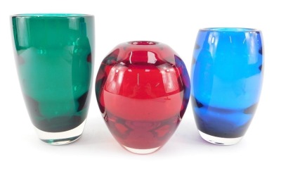 A Whitefriars ruby coloured glass vase, of ovoid form with ribbed banding, pattern number 9584, 14cm high, together with a Whitefriars blue glass vase, pattern number 9587, 15cm high, and a Whitefriars sea green glass vase, designed by Geoffrey Baxter, pa