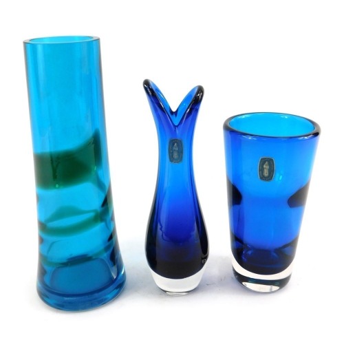 A group of Whitefriars glass, comprising a kingfisher blue cylindrical vase, pattern number 9206, 22cm high, a blue tulip vase, with label, 18cm high, and a kingfisher blue and meadow green trail glass, deigned by Geoffrey Baxter, with label, pattern numb