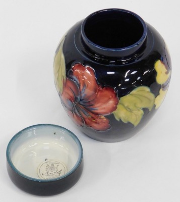 A Moorcroft pottery ginger jar and cover, decorated in the Hibiscus pattern, paper label and impressed marks to underside, 16cm high. - 2