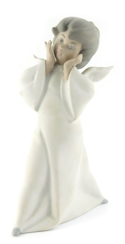 A Lladro matt porcelain figure, modelled as an angel, printed marks, 23cm high.