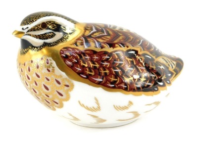 A Royal Crown Derby porcelain paperweight, modelled as a dappled quail, gold stopper, red printed marks, 6.5cm high.