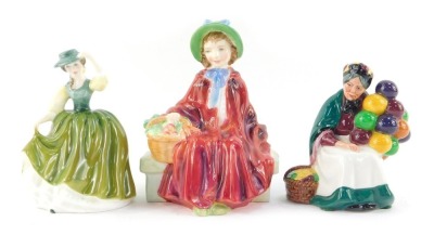 Three Royal Doulton porcelain figures, modelled as Linda HN2106, Buttercup HN3268, and The Old Balloon Seller HN2129.