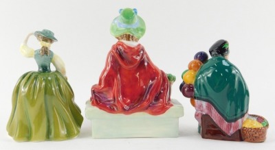 Three Royal Doulton porcelain figures, modelled as Linda HN2106, Buttercup HN3268, and The Old Balloon Seller HN2129. - 2