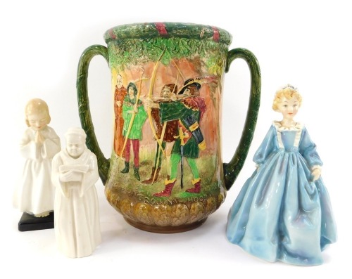 A group of ceramics, comprising a Royal Worcester porcelain figure of Grandmother's Dress, JO81, a Royal Worcester candle snuffer, modelled as a monk holding a book, a Royal Doulton figure Bedtime HN1978, and a Royal Doulton two handled vase, decorated in