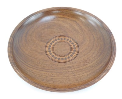 A Padauk shallow fruit bowl, decorated internally with connecting circle in varying woods, bearing label to underside Made by D McGriffin, Surlingham, Norfolk, 30cm diameter.