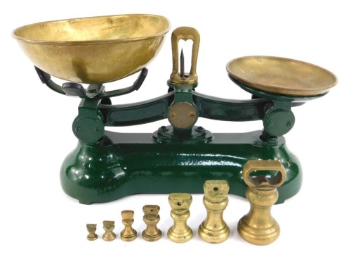 A set of green cast metal and brass scales, 20cm high, with various brass weights.