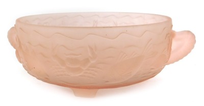 A pink frosted glass two handled bowl, relief moulded with fish, crustaceans, etc, on four tapering feet, 10cm high, the bowl 23.5cm diameter.