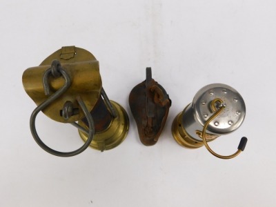 Mining interest. A miniature Ashington Collier reproduction miners lamp, 17cm high, a paraffin wick burner lamp, 14cm high, and a brass burner, 24cm high. (3) - 3