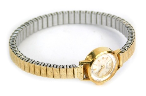 A Heloisa lady's wristwatch, with small silvered coloured numeric dial, with incabloc movement, serial number 1754, in yellow metal case stamped 18ct 750, on expanding gold plated and stainless steel bracelet, 18.1g all in.