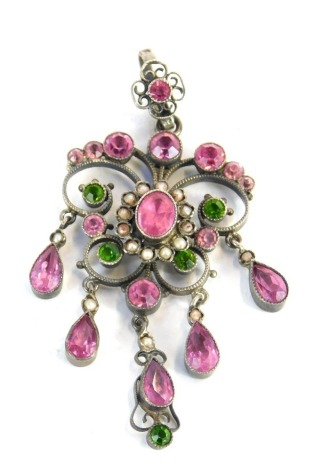 A late Victorian Belle Epoque silver pendant, with seed pearls, and red and green paste stones, 7cm.