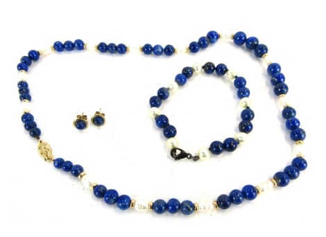 A lapis and cultured pearl jewellery set, comprising necklace with marquise shaped clasp, yellow metal stamped 14kt, 48cm long, associated lapis and cultured pearl bracelet with silver clasp, and a pair of lapis 9ct gold studs, 52.8g all in.