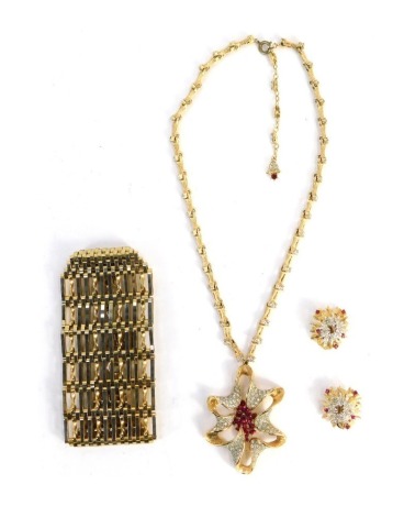 A 1950s costume jewellery set, comprising abstract necklace and matching earrings, set with white and red paste stones, and a rolled gold gate bracelet.