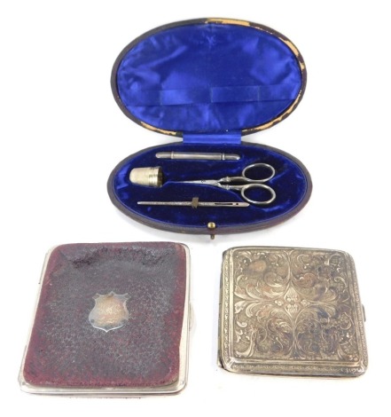 A group of assorted silver, comprising a silver plated cigarette case with floral design decoration, leather and silver crested coin purse and a cased manicure set. (3)