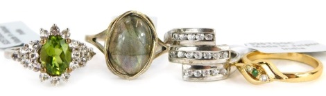 Four dress rings, comprising two silver gilt examples, each stone set, white metal stamped 925, with tags and one pouch.