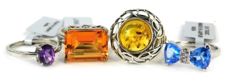 Four Gems TV dress rings, each stone set to include imitation amber, blue, purple, and orange stones, in various settings, white metal stamped 925, with labels and pouches.