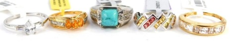 Five dress rings, comprising a turquoise and cz set dress ring, multi stone dress ring, two silver gilt dress rings, mainly white metal stamped 925, with tags and pouches.