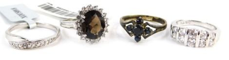 Four dress rings, mainly Gems TV and Gemporia, comprising a five channelled cz dress ring, smoky quartz and cz dress ring, and two other stone set rings, each white metal stamped 925, two boxed. (4)