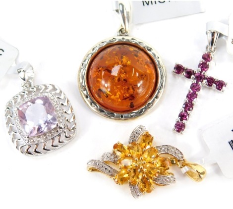 Four gem set pendants, comprising a crucifix with pink stones, a floral scroll with white and cz stones, amber pendant and an amethyst pendant, each in white metal frame stamped 925, with tags and pouches.