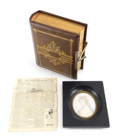 A Victorian leather and gilt tooled album, containing various portrait studies, together with a miniature Daily Telegraph newspaper for Saturday May 15th 1954, and a portrait miniature depicting a lady, indistinctly signed, 7cm x 5.5cm. (3)