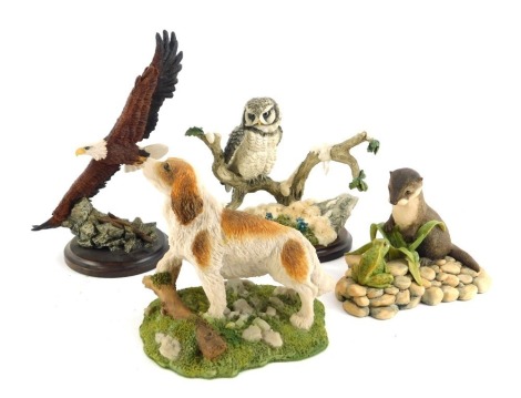 A group of resin animal figure groups, comprising Border Fine Arts otter and frog group, 7.5cm high, Coalport model of a dog, Country Artists Bald Eagle Soaring CA626 (small), and Country Artists Hawk Owl with Spring Gentins, 12cm high. (a quantity)