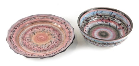 Two items of Scandinavian studio pottery, comprising bowl and dish, each decorated with leaves and fruit, against a graduated pink ground, indistinctly signed to underside, the bowl 22cm diameter, the dish 28cm diameter.