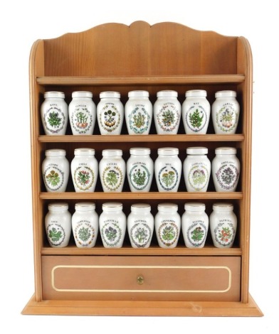 A group of twenty two Franklin Mint porcelain herb jars and covers, to include Celery, Sage, Parsley, Cinnamon, etc, each 8.5cm high, contained in an oak veneer shelving rack, 49cm high.