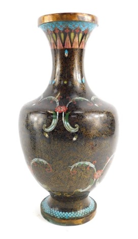 A Japanese cloisonne vase, decorated with flowers, scrolls, etc, against a black ground, with wire work swirl decoration, 33cm high.