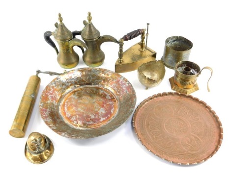 A group of brass ware, to include chargers, chamber stick, Eastern brass circular dish, 12cm diameter, iron dated 1881, Eastern jugs with leather bound handles, 24cm high, etc. (a quantity)