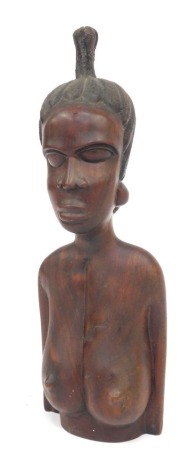 An African hardwood carving, depicting head, shoulders and torso of a female, 51cm high.