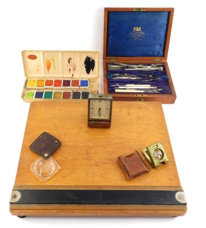 A group of collectables, to include a Talens tin cased watercolour set, an oak cased drawing set, lighter, drawing board, etc.